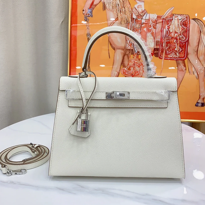 Clean Pale White Grey Fine Grain Sharp Edged Structured Rectangular Handbag With Polished Silvery Twist Lock Hardware And Hanging Decorative Metal Padlock Charm